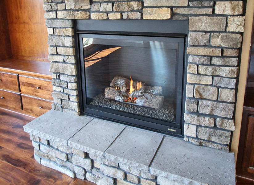 Rock face fireplace in new home at Chinook Place, by Universal Construction